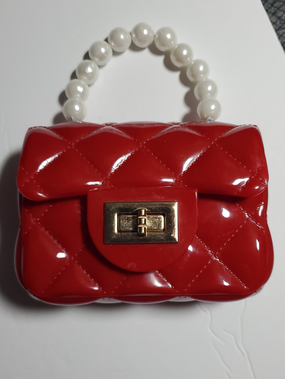 Red Quilted Jelly Purse With Imitation Pearl Handle And Turn Lock Closure Glossy